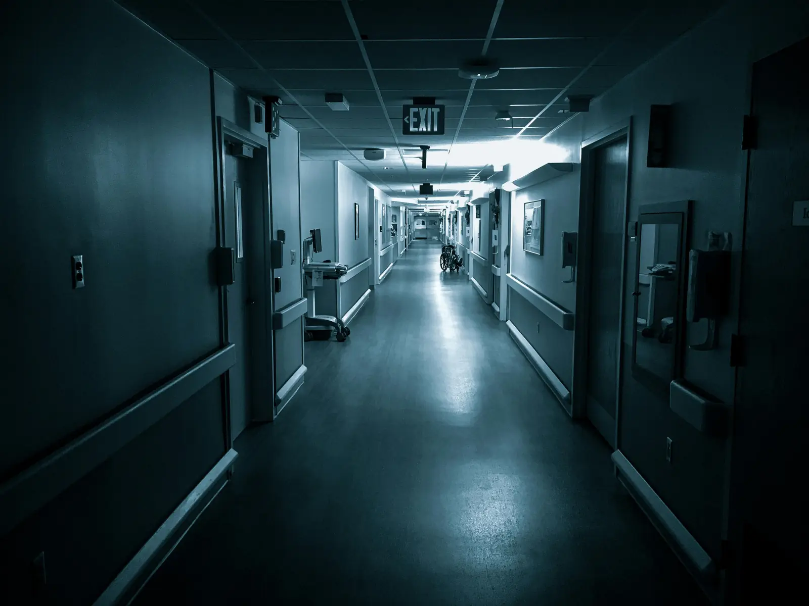 A long hospital corridor at night — the diagnostic frame.