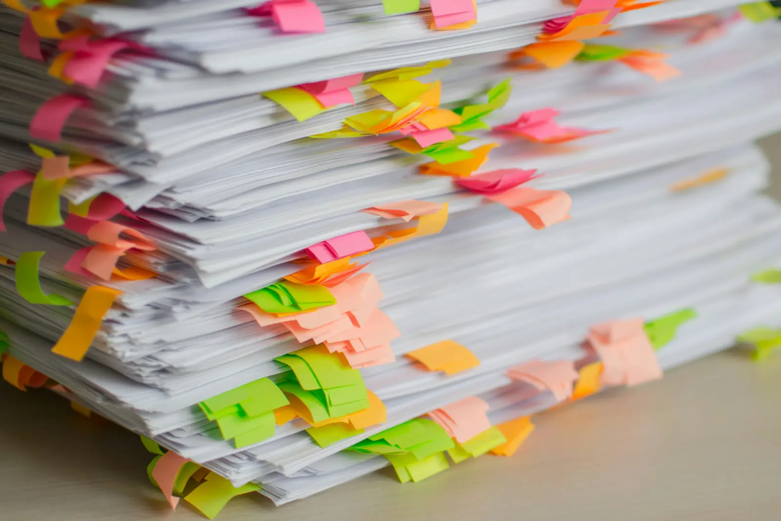 A stack of hospital financial documents under inspection — the intervention frame.